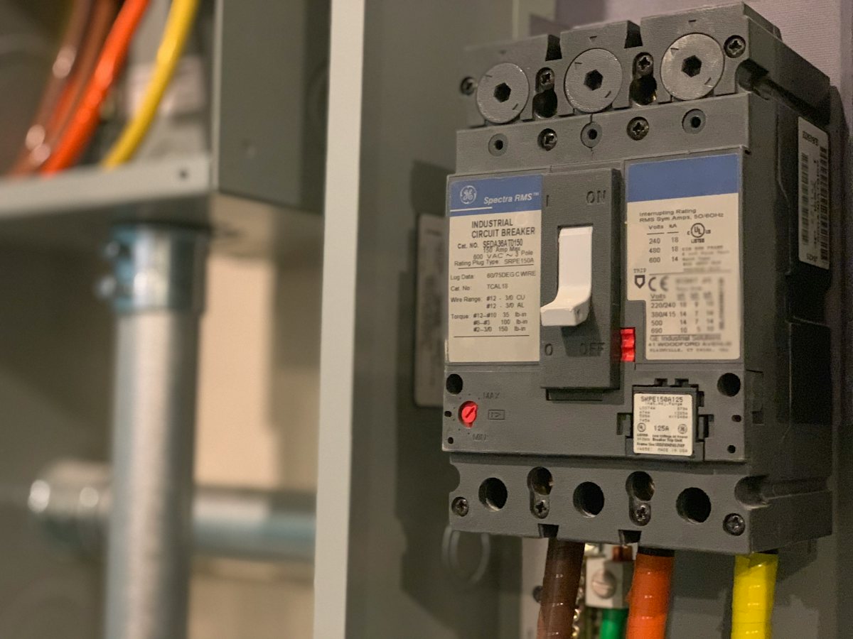 Open electrical panel showing breakers and wiring inside