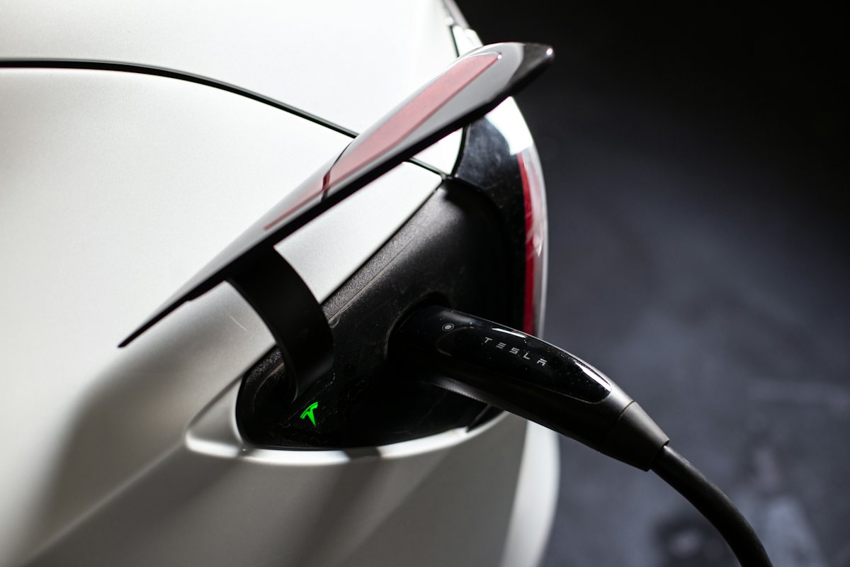 Electric car plugged into a charger in a home garage