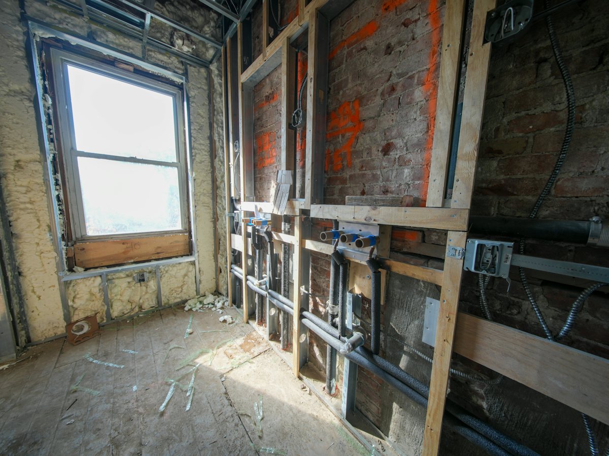 Room under renovation with open framing and exposed wiring