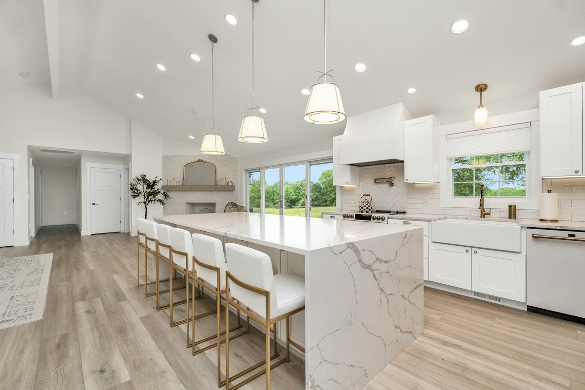 Kitchen with a marble island and white cabinets